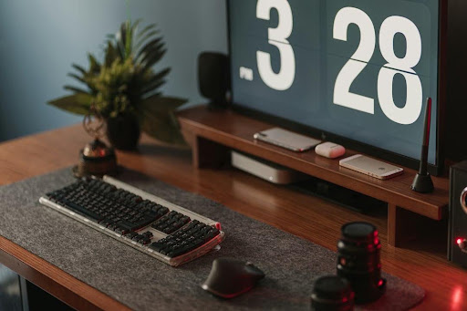 a computer desk with a keyboard and mouse